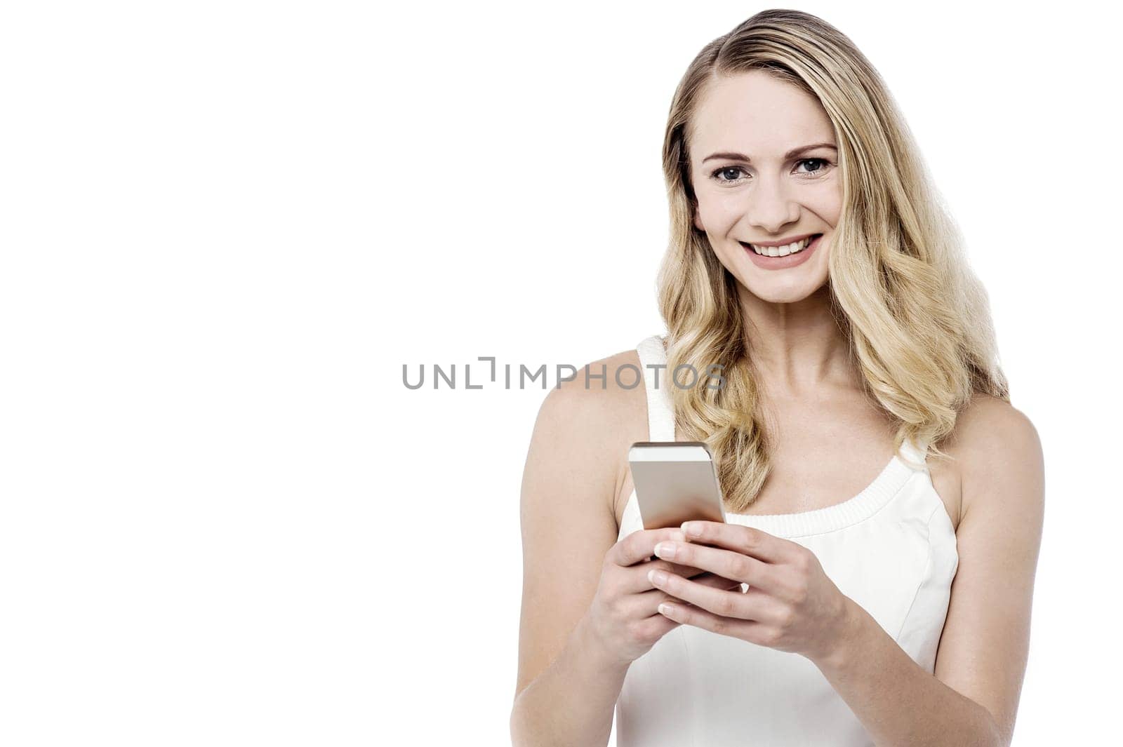 Smiling woman texting from her mobile phone