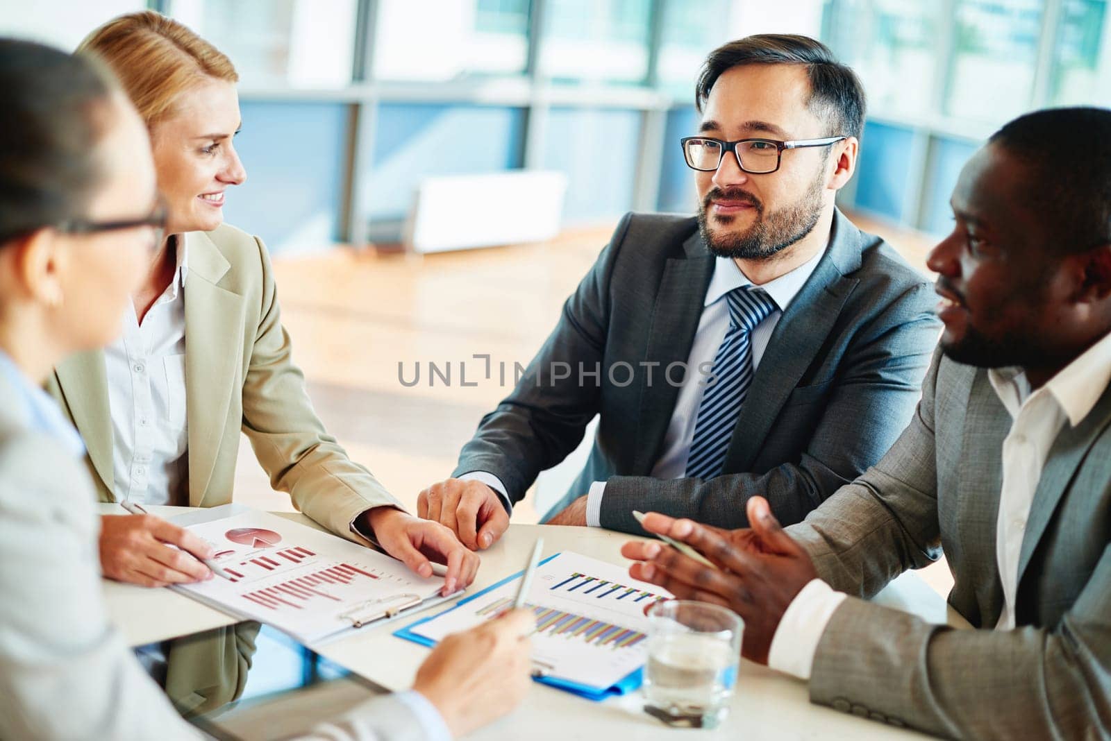 Confident businessman looking at his colleagues at meeting