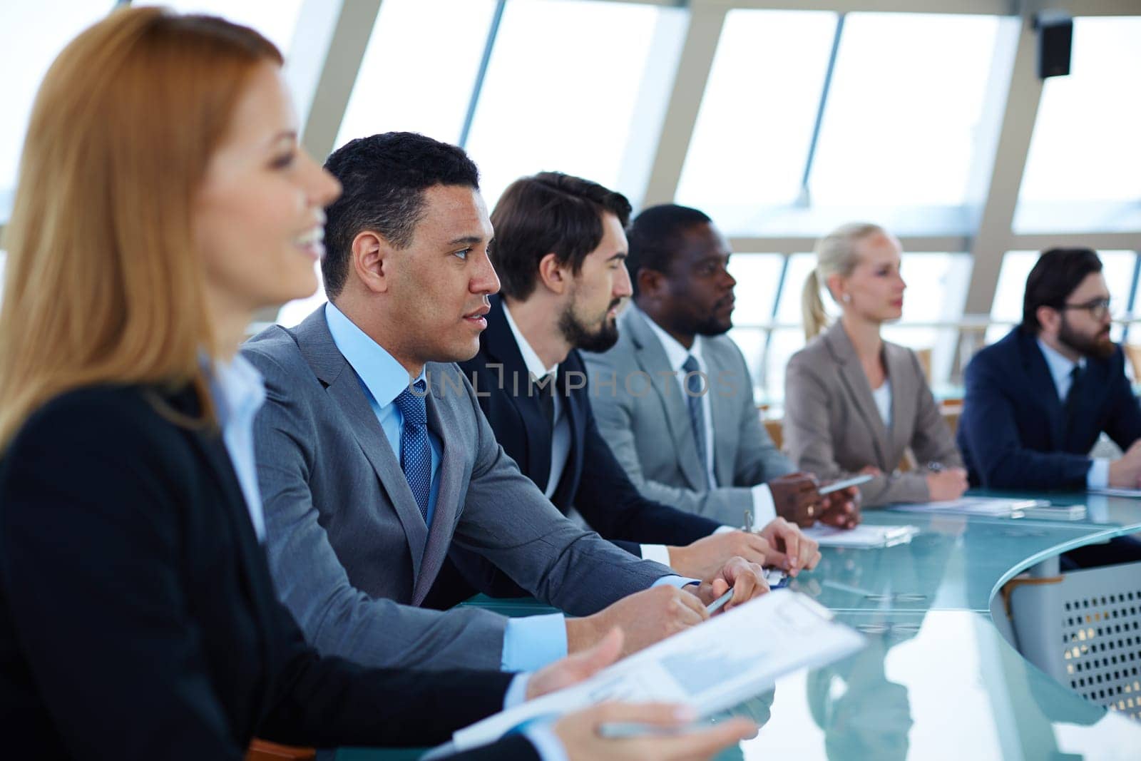 Row of serious business people attending seminar