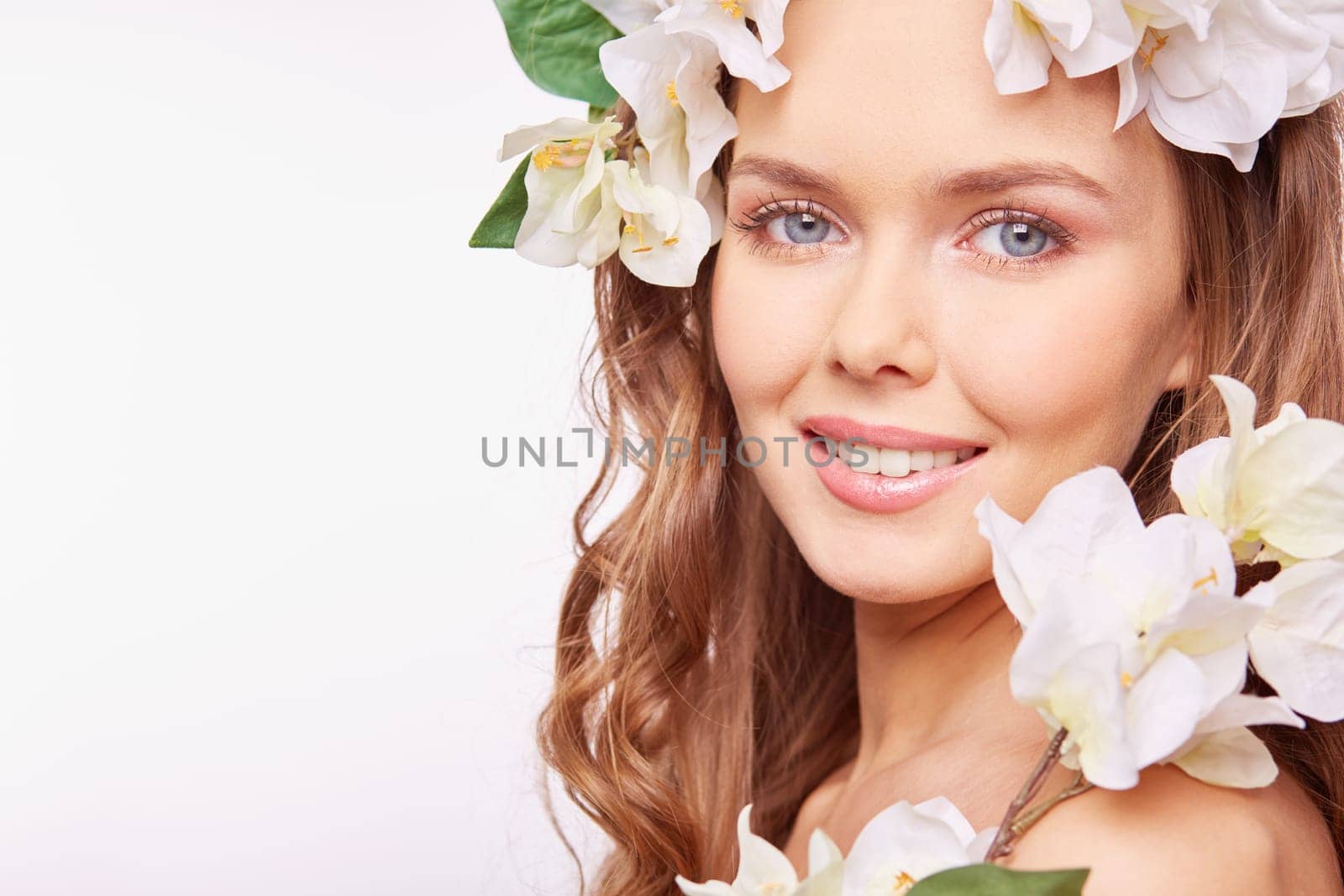Young woman in floral wreath looking at camera