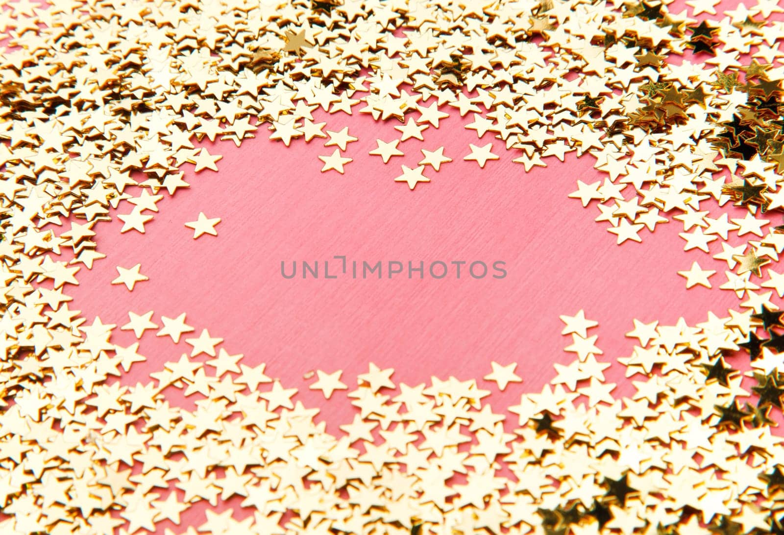 frame made of decorative stars on pink background