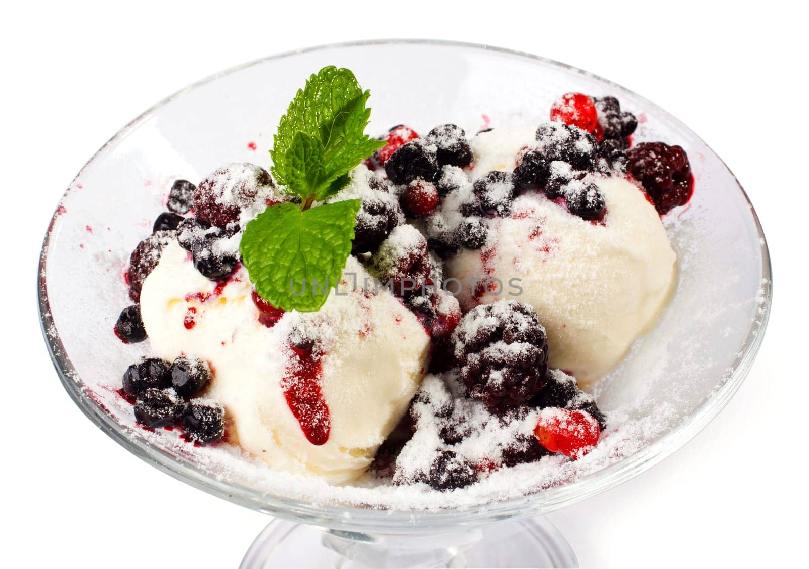 ice cream with raspberries blueberries cranberries currants and mint on a white background