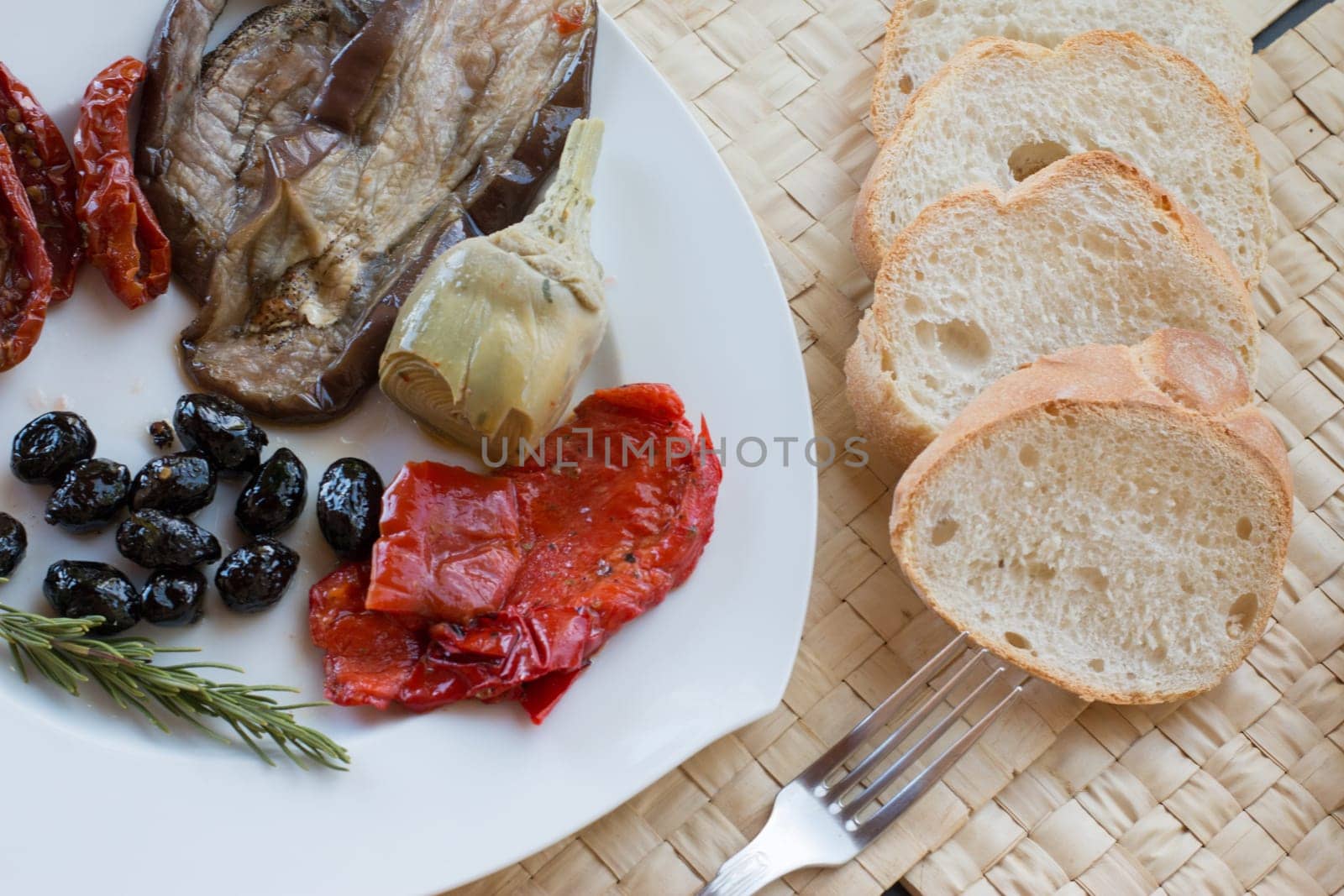 Italian antipasti as dinner appetizer. Tomatoes, Olives, paprika and more.