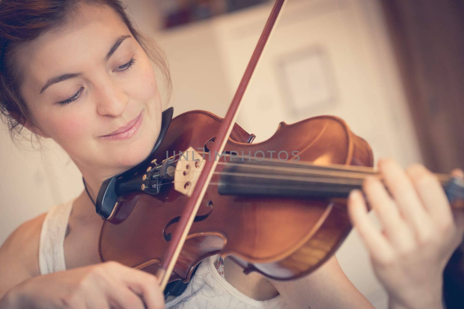 Pretty young girl practices on her violin, acoustic music