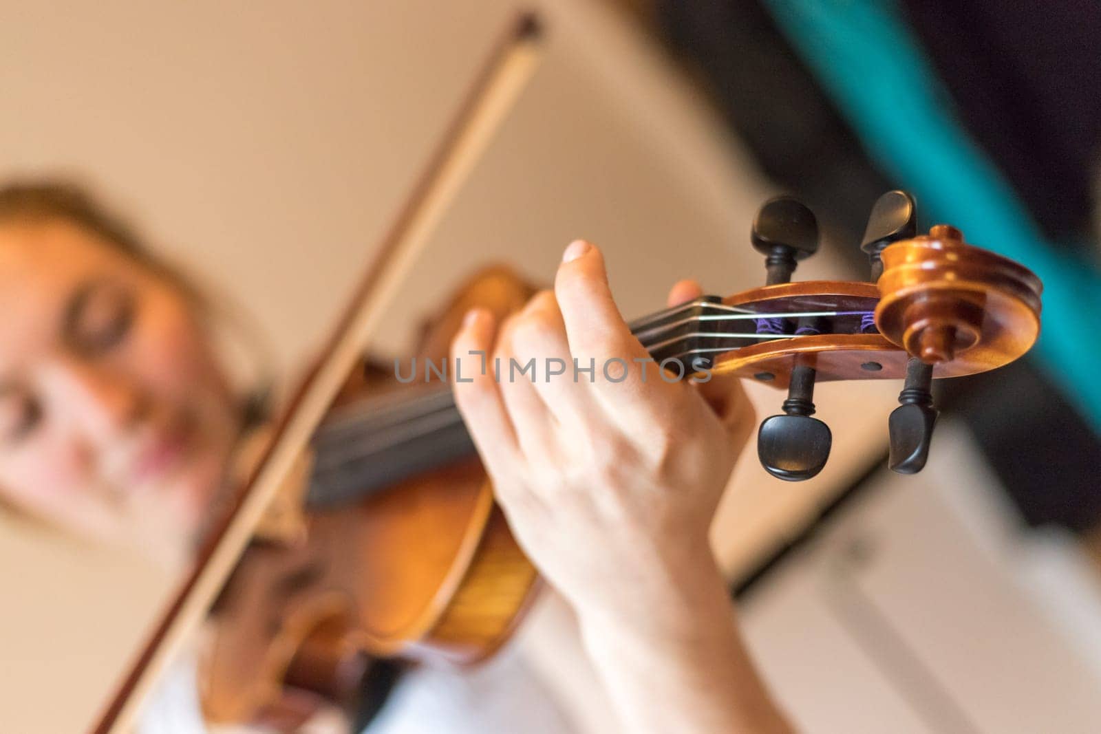 Pretty young girl practices on her violin, acoustic music