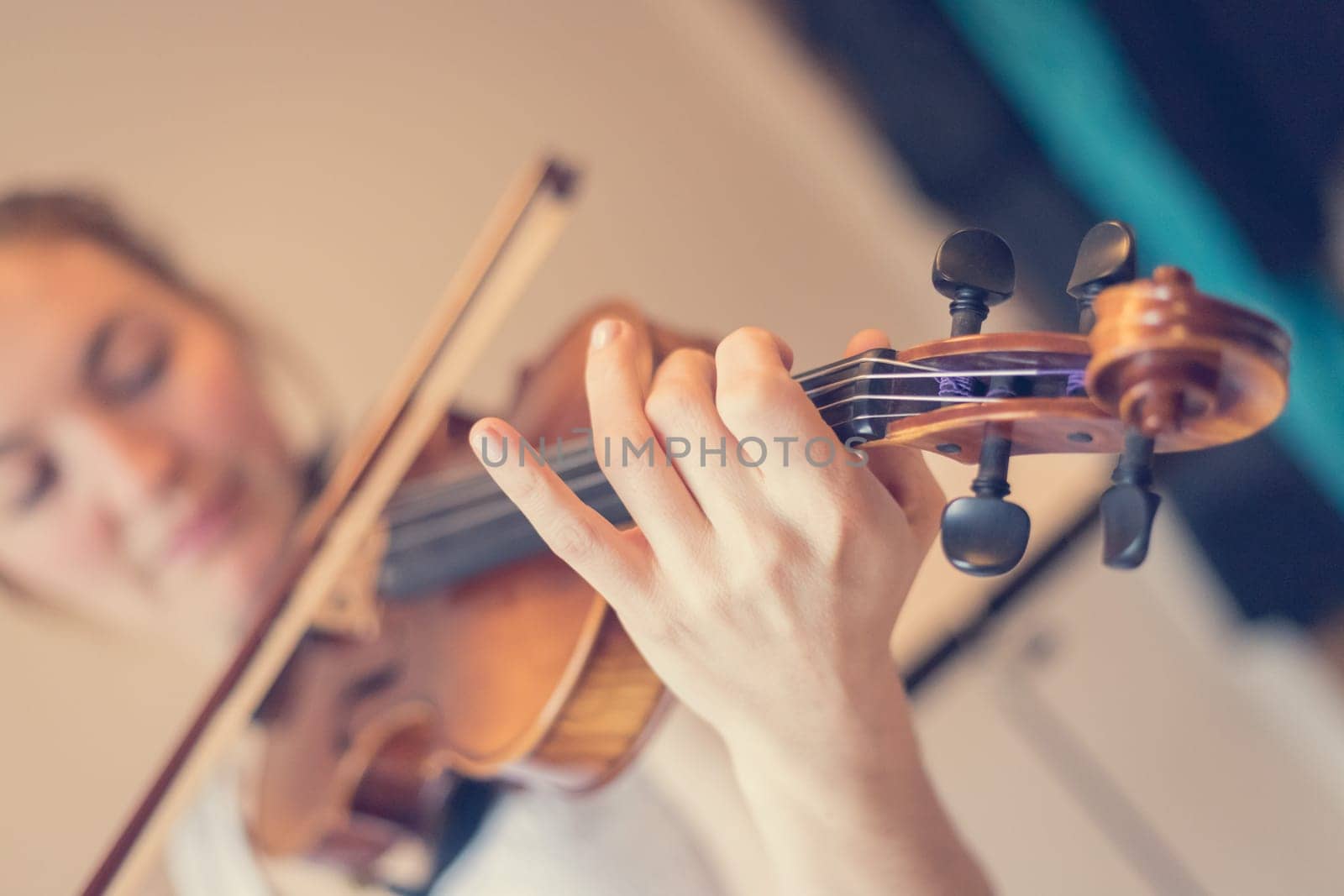 Pretty young girl practices on her violin, acoustic music