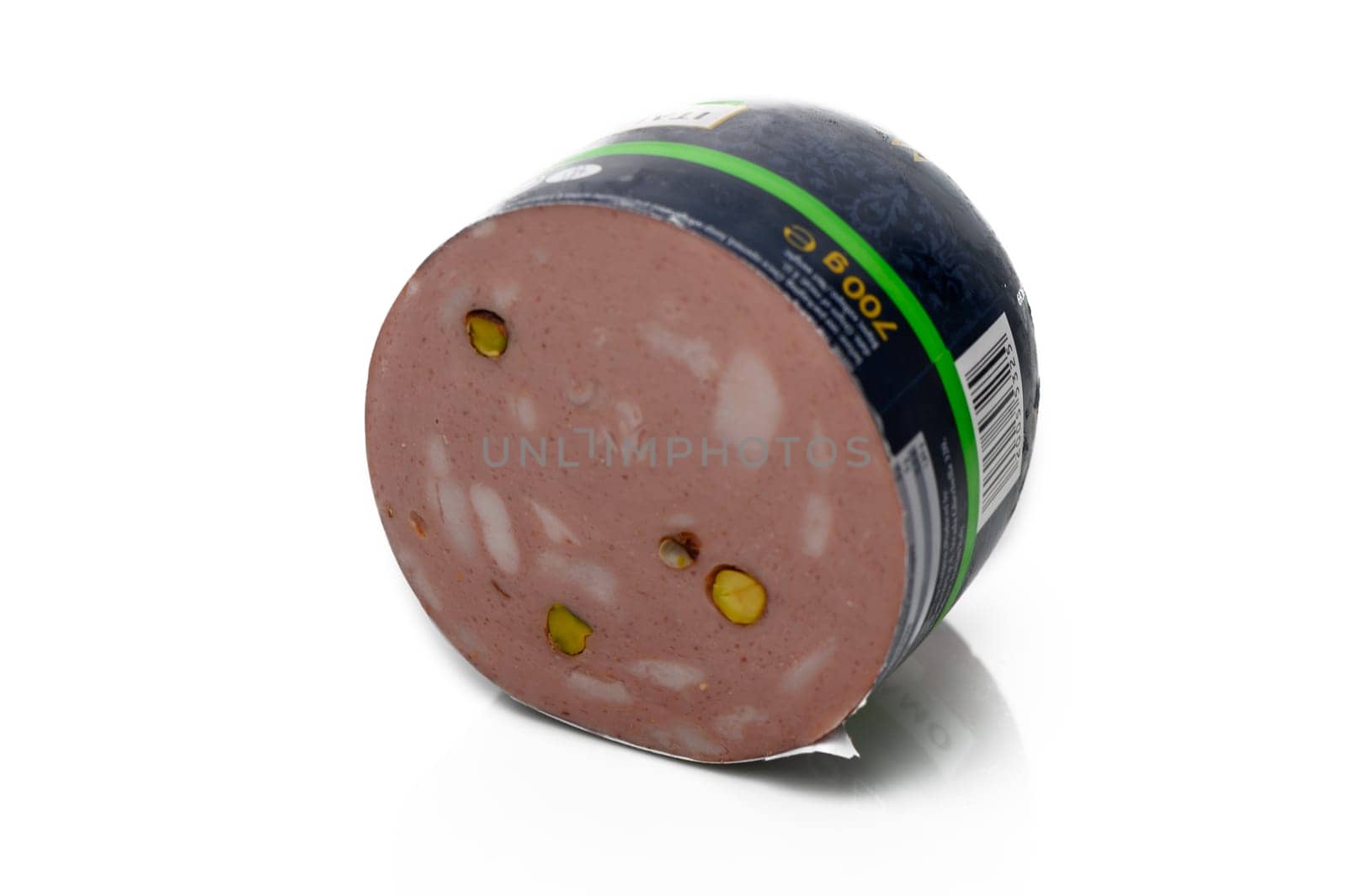 A round slice of deli meat reveals a blend of flavors, with pistachios adding a pop of color and texture.