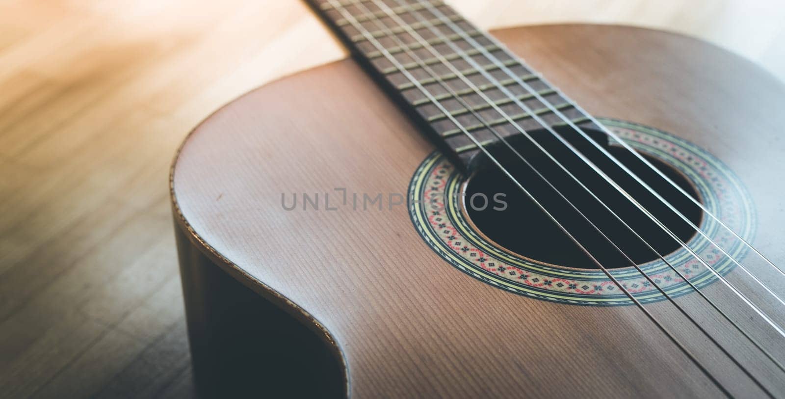 Cutout of a classical guitar corpus and strings, closeup