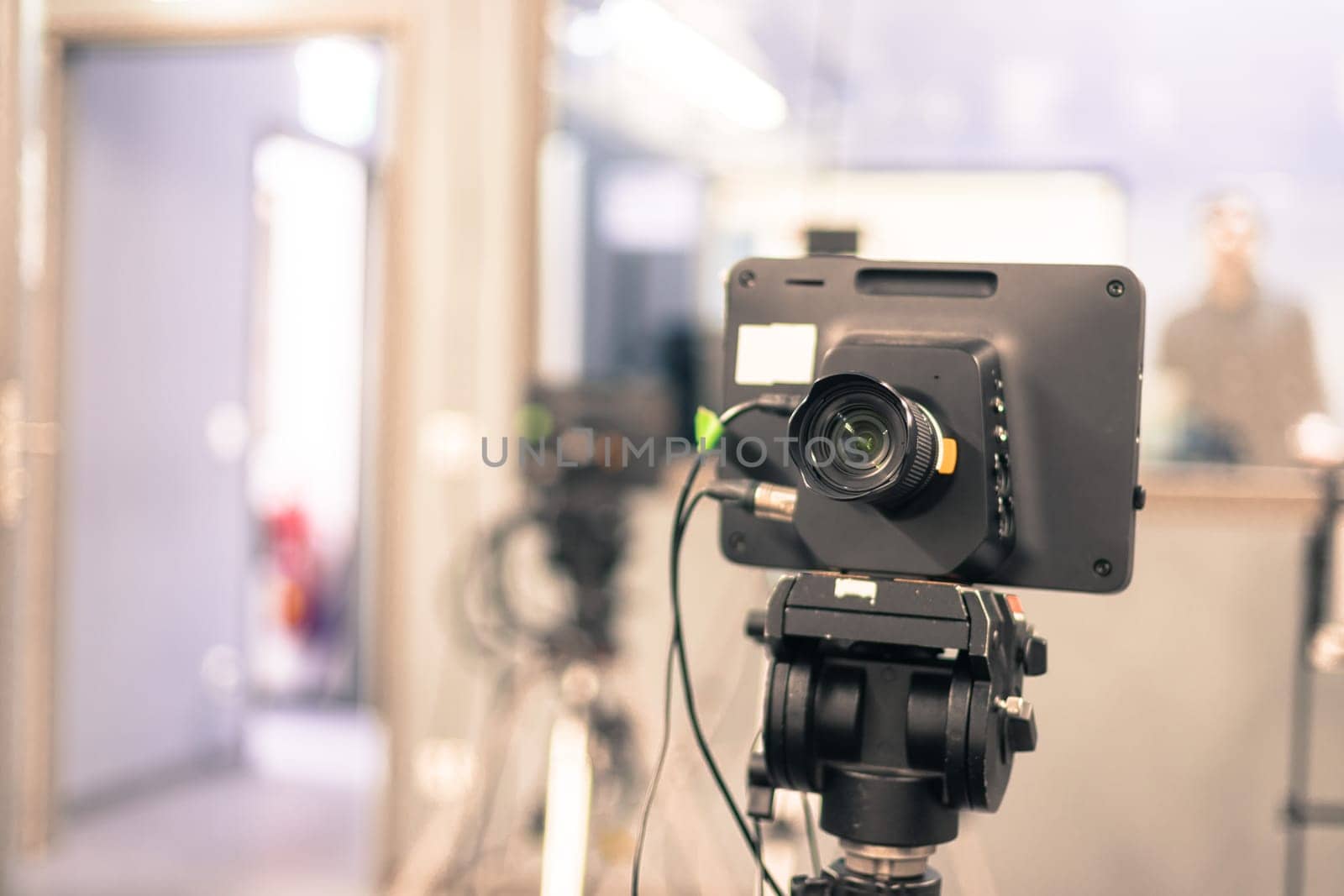 Lens of a film camera in an television broadcasting studio, spotlights and equipment