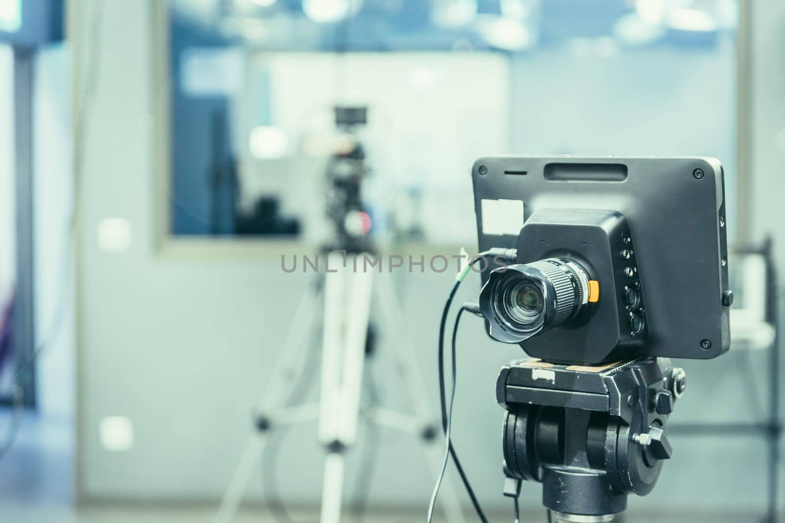 Film camera on a tripod in a television broadcasting studio