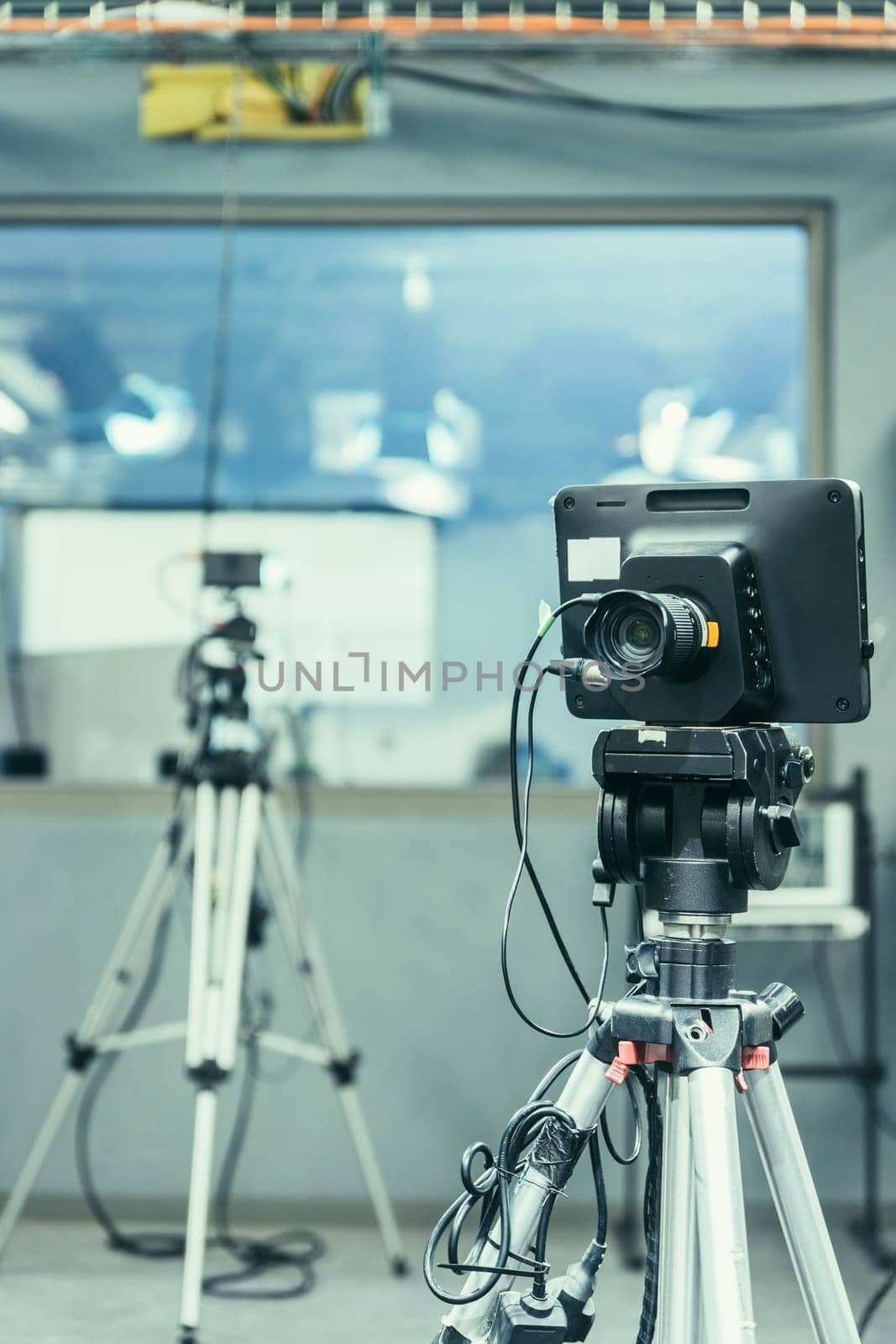 Film camera on a tripod in a television broadcasting studio