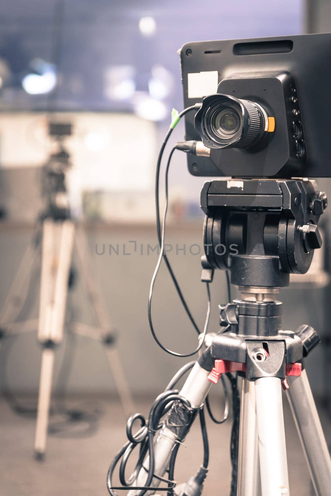 Film camera on a tripod in a television broadcasting studio