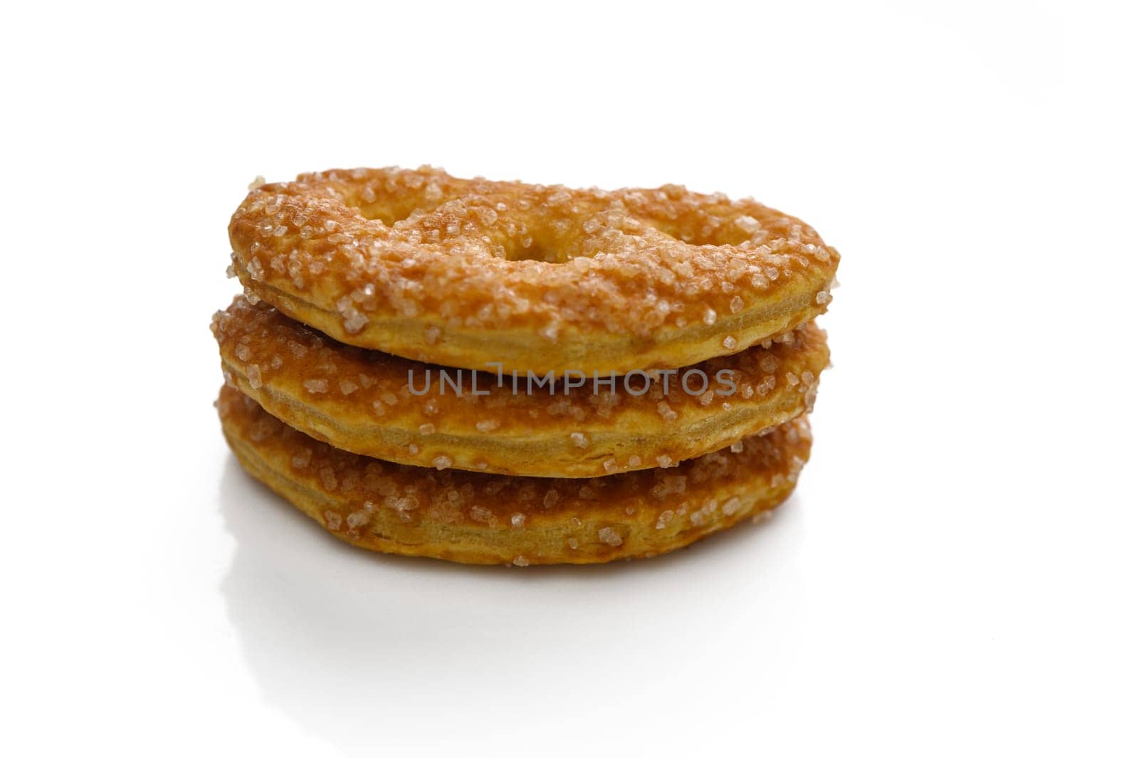 Three golden pastries piled high, glittering with sugar, inviting an indulgent treat for sweet lovers.