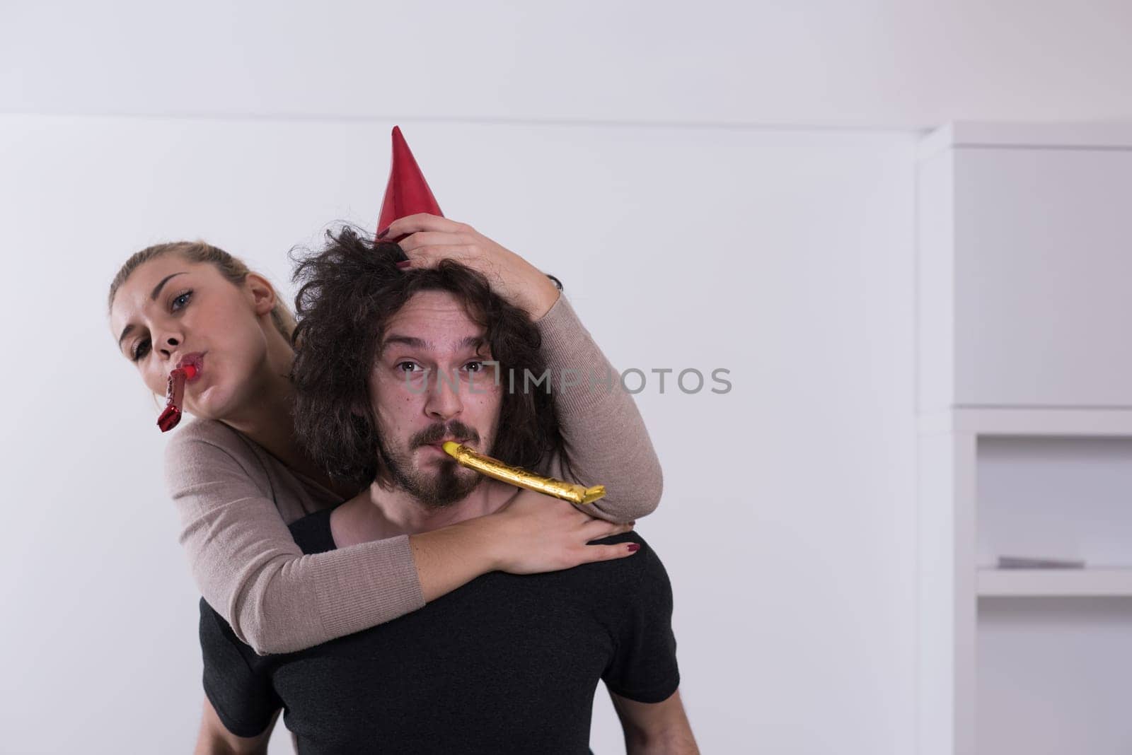young romantic  couple in love  celebrating and blowing confetti decorations
