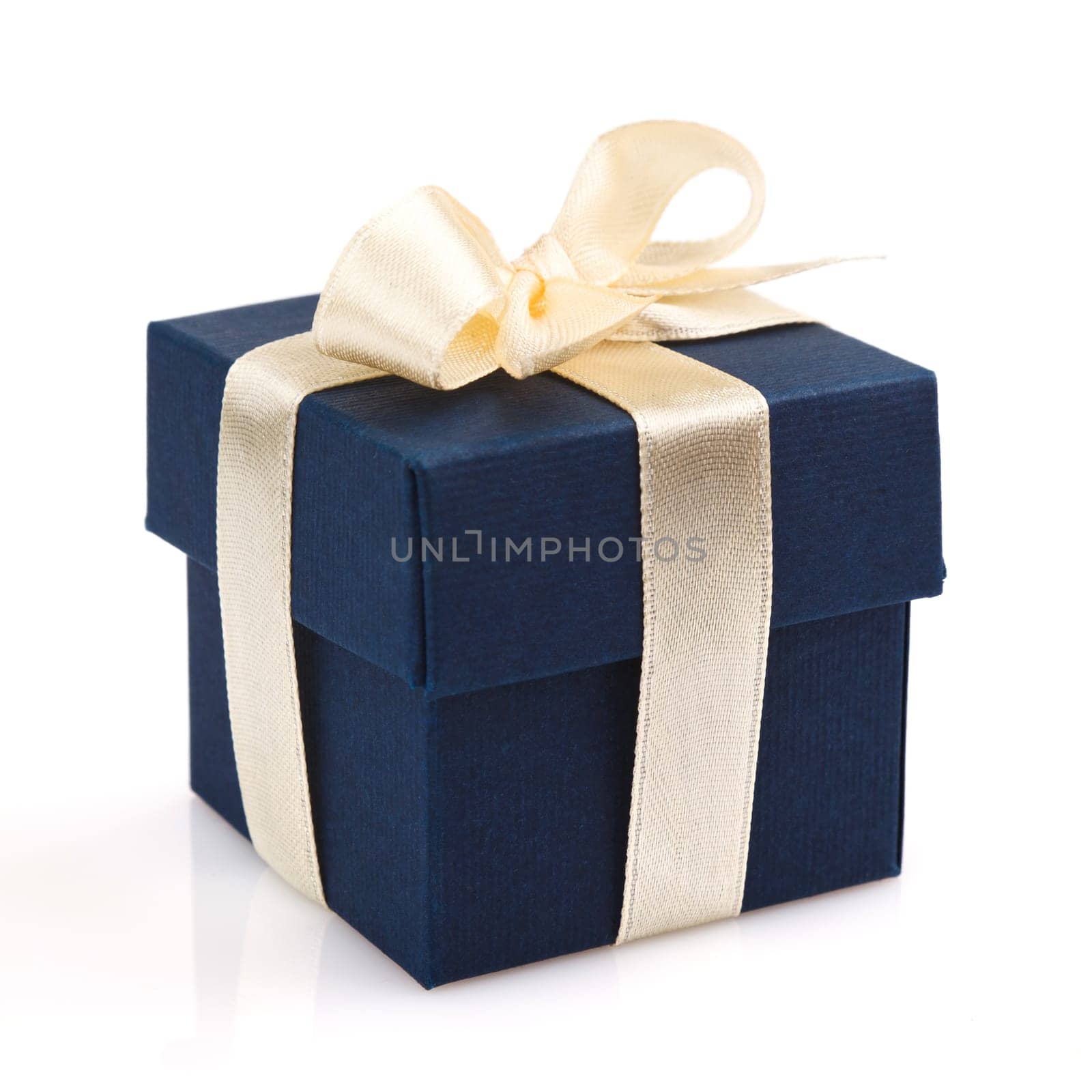 dark blue gift box with golden ribbon and bow isolated on white