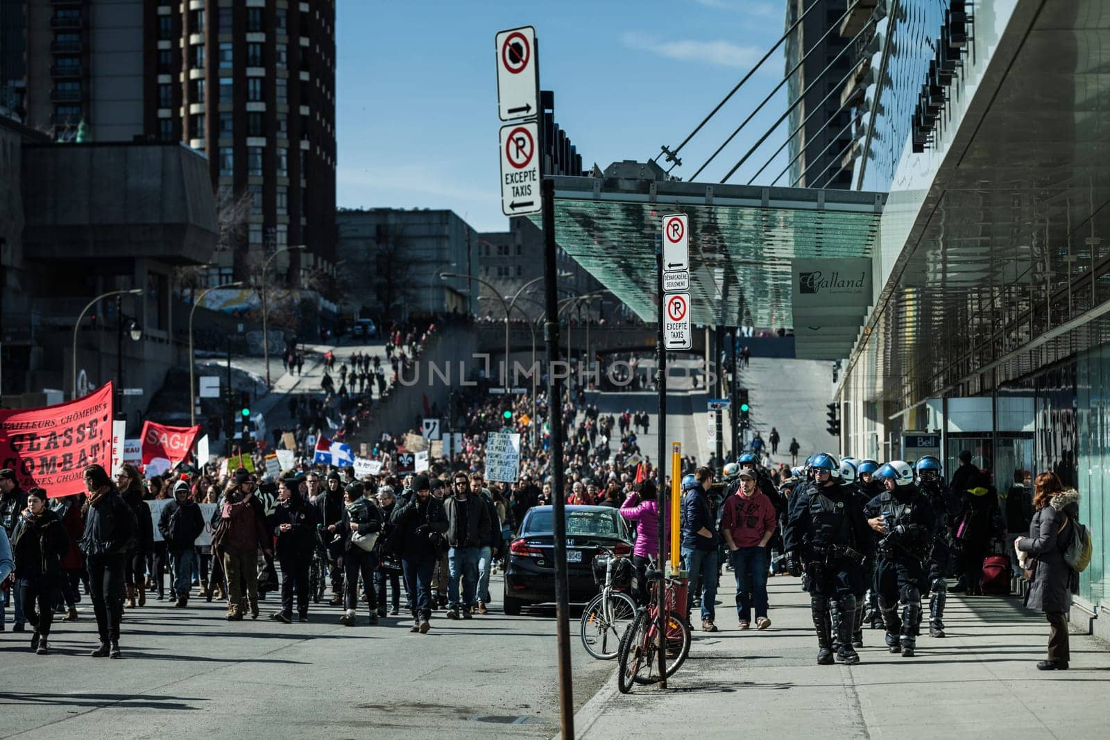 MONTREAL, CANADA, APRIL 02 2015. Riot in the Montreal Streets to counter the Economic Austerity Measures. Cops Following Marchers in case of something Goes Wrong