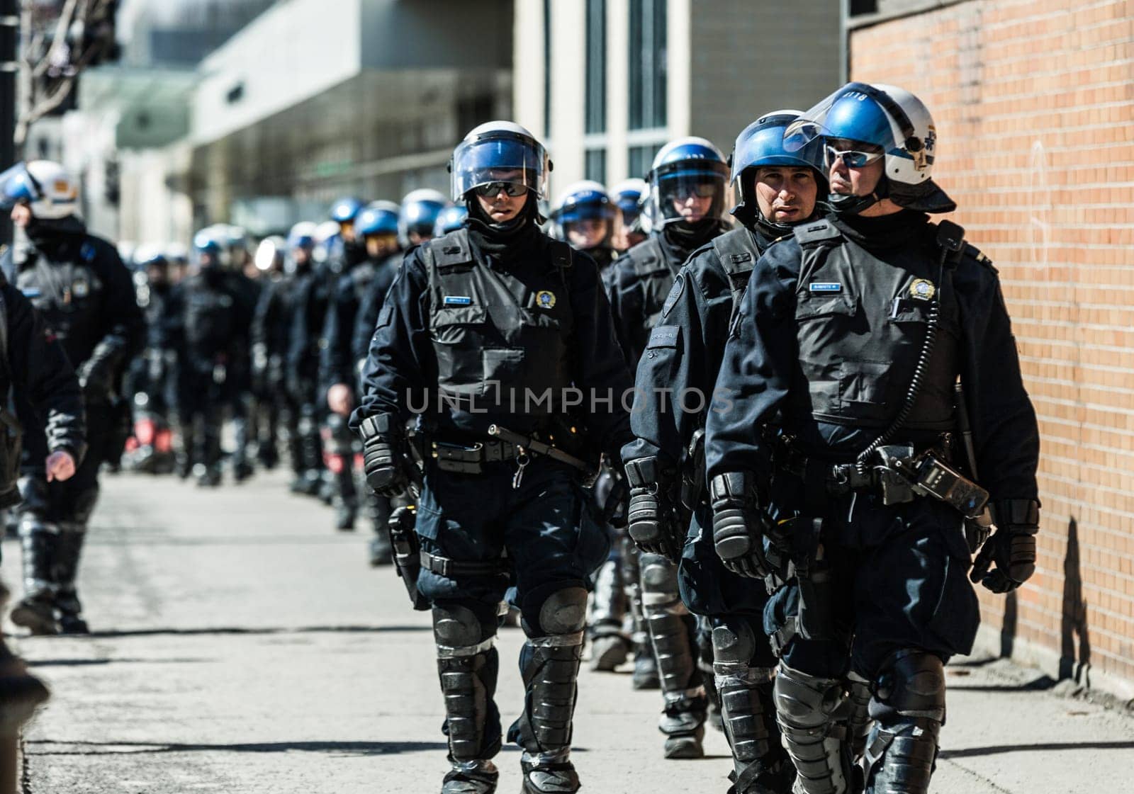 MONTREAL, CANADA, APRIL 02 2015. Riot in the Montreal Streets to counter the Economic Austerity Measures. Cops Following Marchers in case of something Goes Wrong