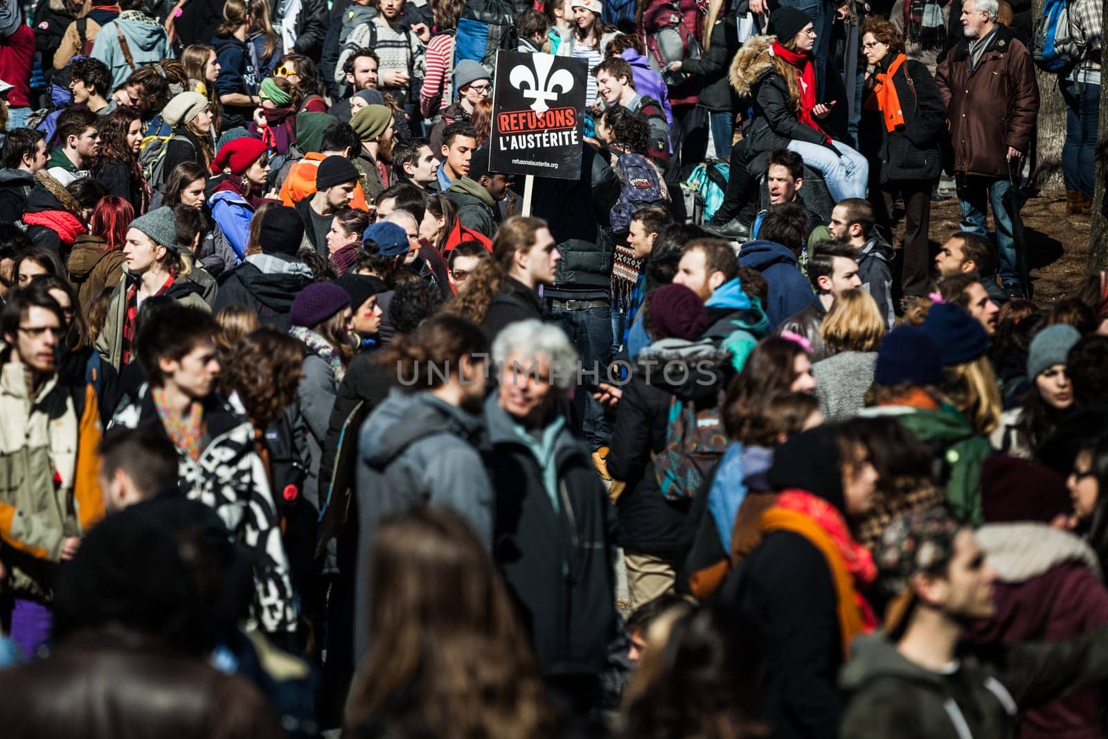 MONTREAL, CANADA, APRIL 02 2015. Riot in the Montreal Streets to counter the Economic Austerity Measures. Crowd with Placard, Flags and Signs Walking in the Streets