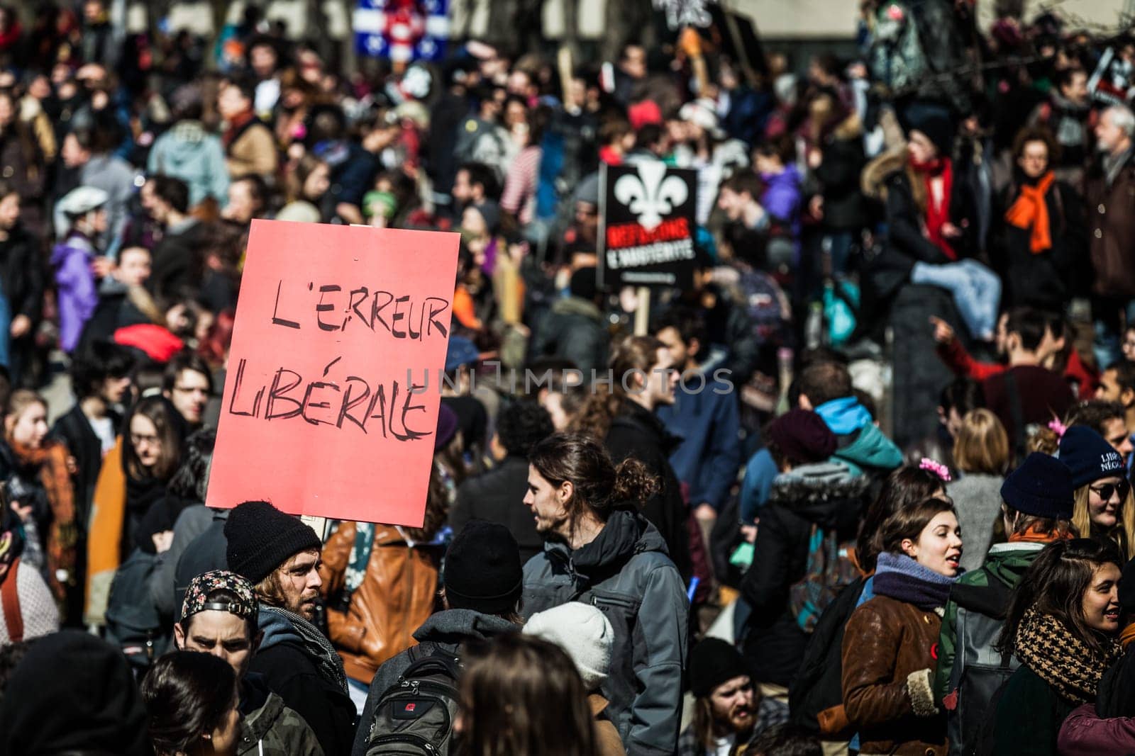 MONTREAL, CANADA, APRIL 02 2015. Riot in the Montreal Streets to counter the Economic Austerity Measures. Crowd with Placard, Flags and Signs Walking in the Streets