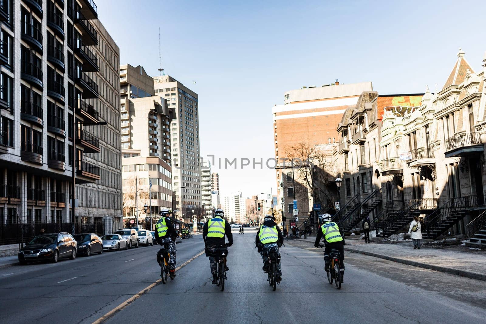 MONTREAL, CANADA, APRIL 02 2015. Riot in the Montreal Streets to counter the Economic Austerity Measures. Four Cops using Bike for Fast and easy Moving.