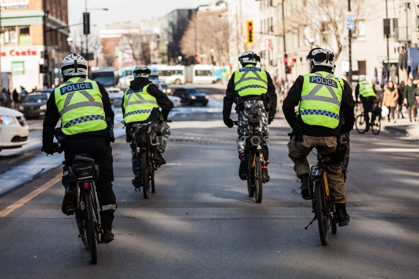 MONTREAL, CANADA, APRIL 02 2015. Riot in the Montreal Streets to counter the Economic Austerity Measures. Four Cops using Bike for Fast and easy Moving.