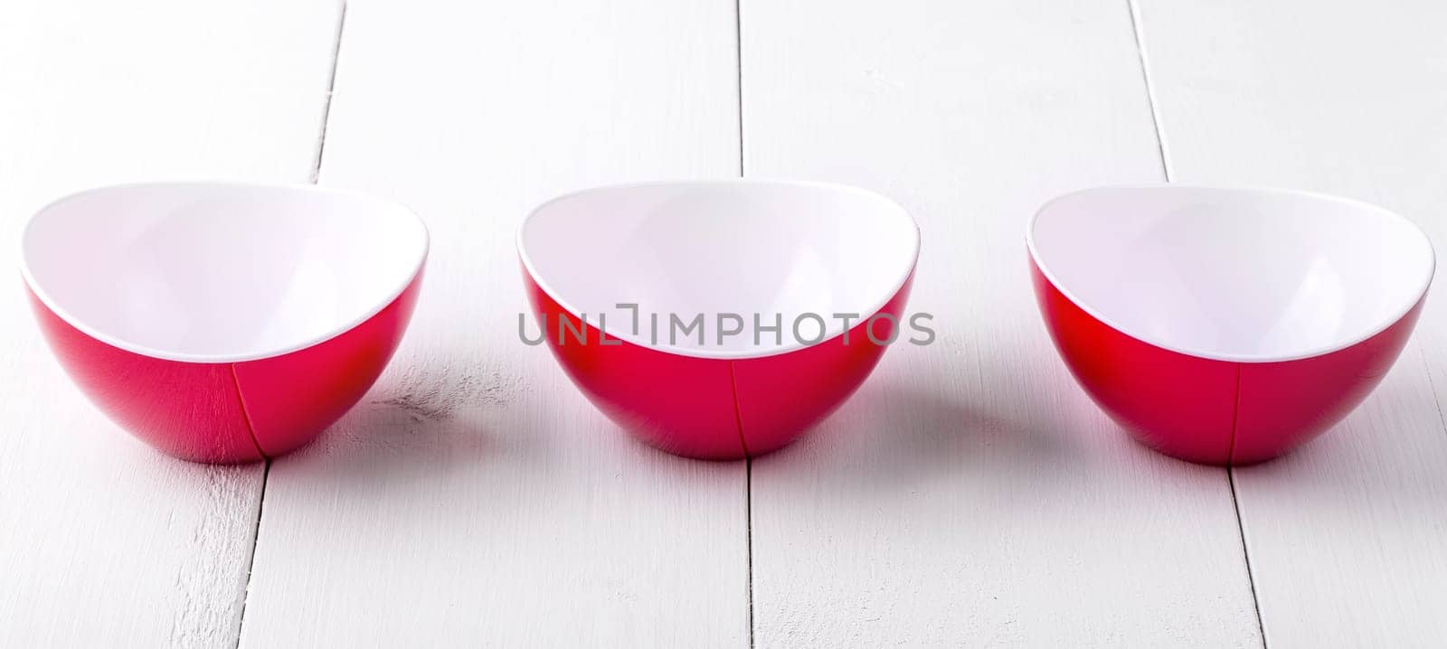 An three empty red cups on a white wooden table