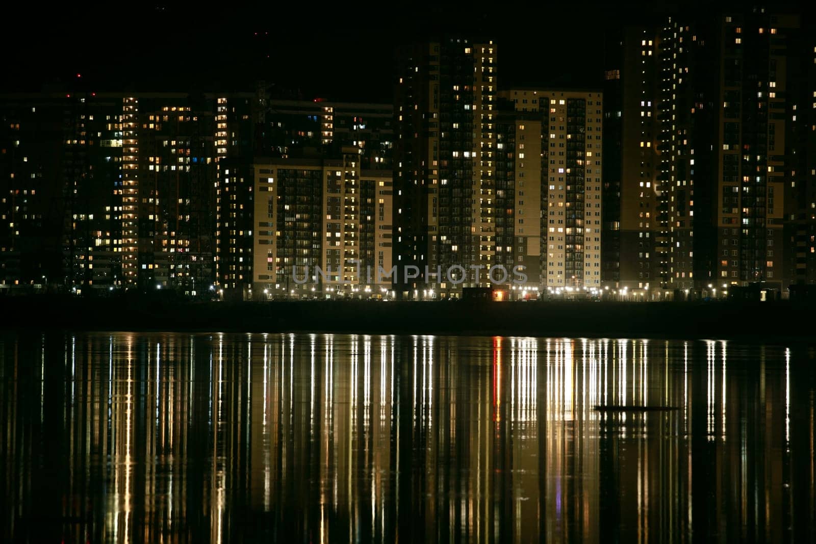 skyscrapers reflected in water at night panorama down up