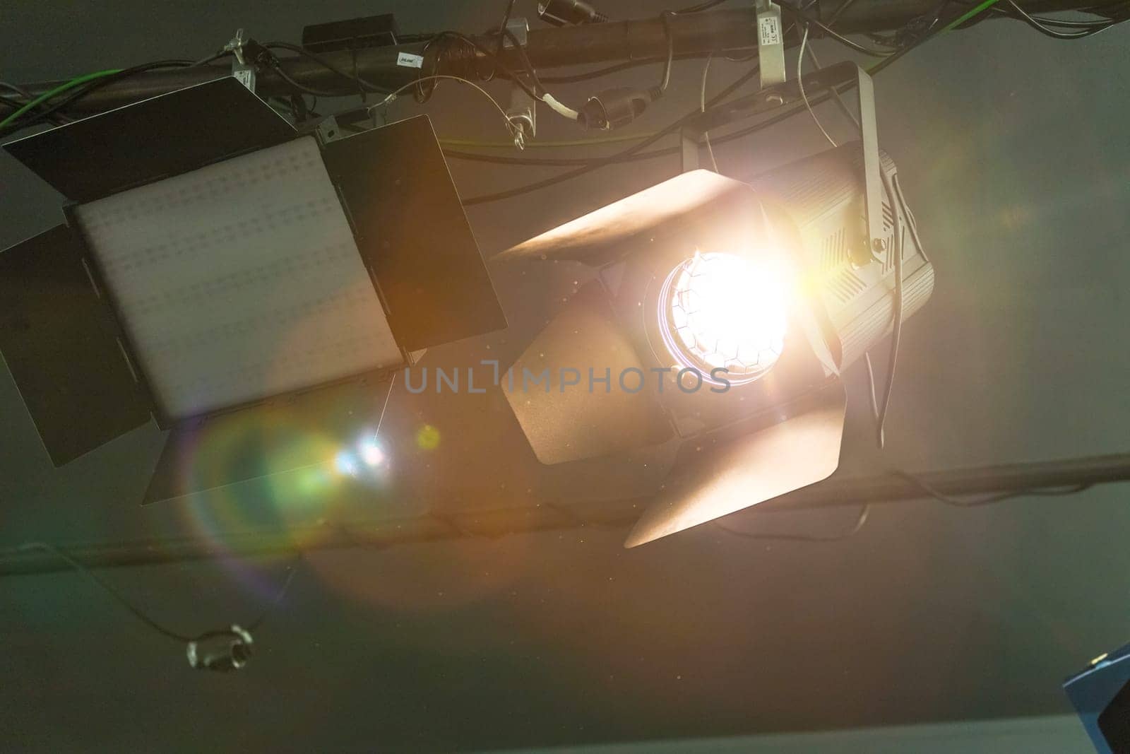 Professional orange studio spotlight hanging on the ceiling.
