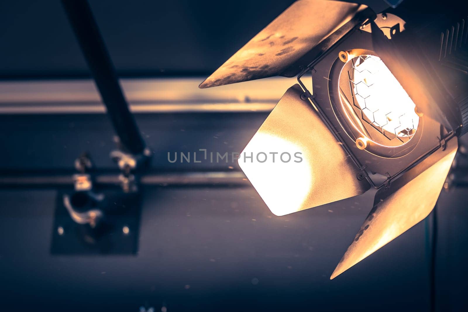 Professional orange studio spotlight hanging on the ceiling.