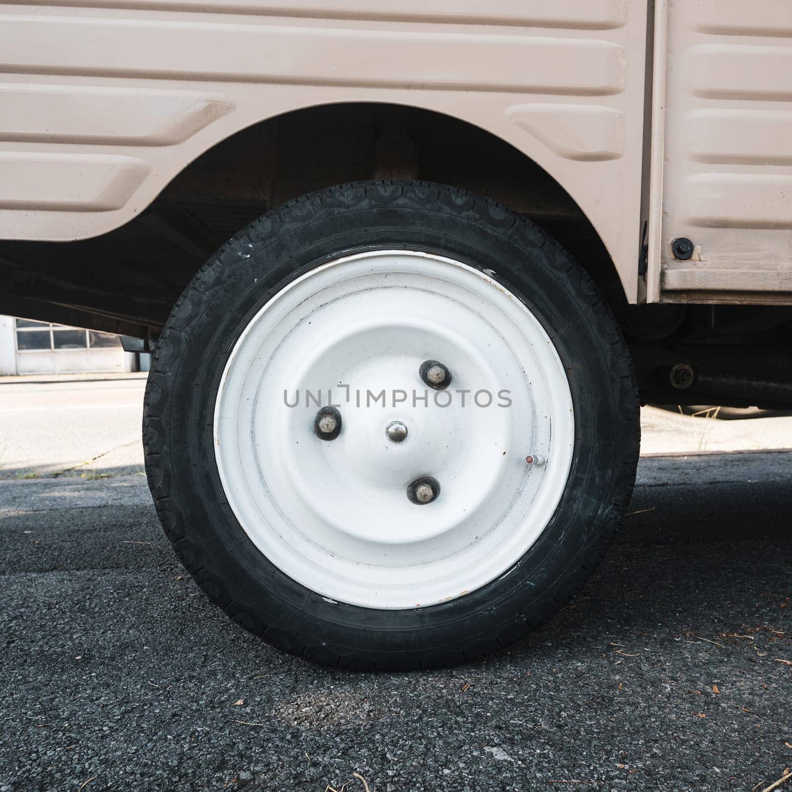 Vintage car white wheel detail shot, retro utilitarian vehicle