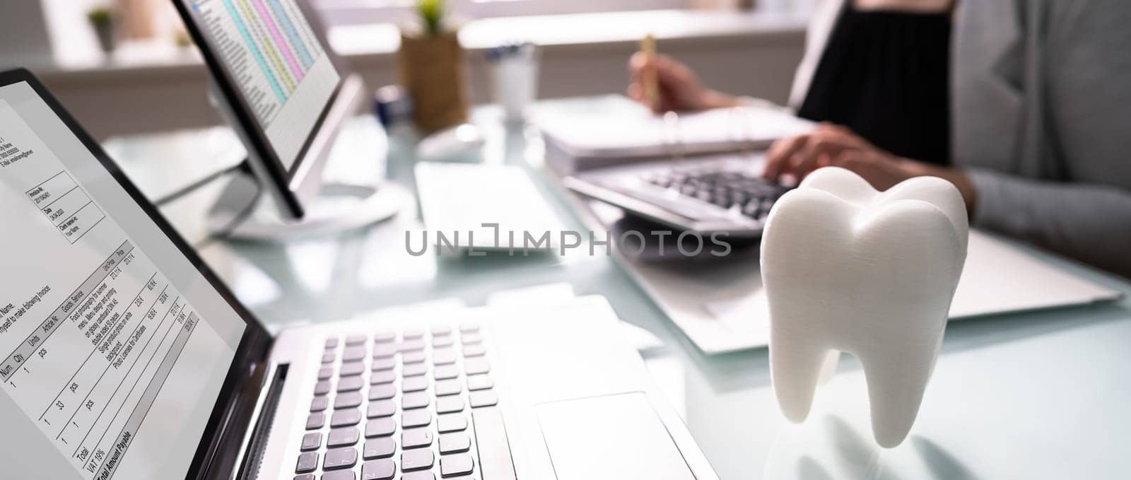 Dentist Bill And Tax Paperwork At Desk