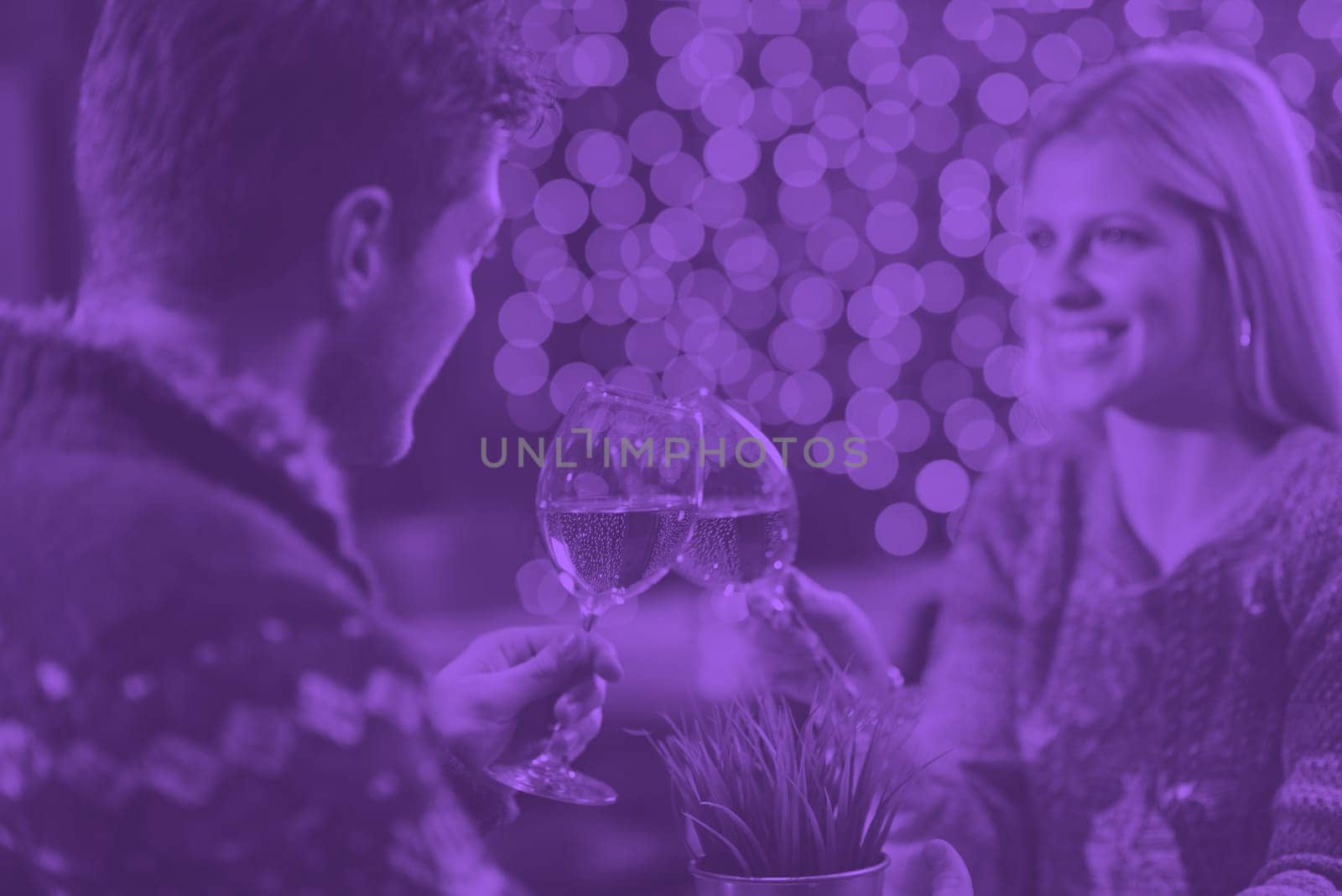 romantic evening date in restaurant  happy young couple with wine glass tea and cake duo tone