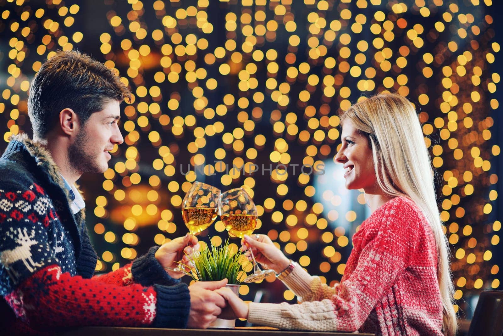 romantic evening date in restaurant  happy young couple with wine glass tea and cake