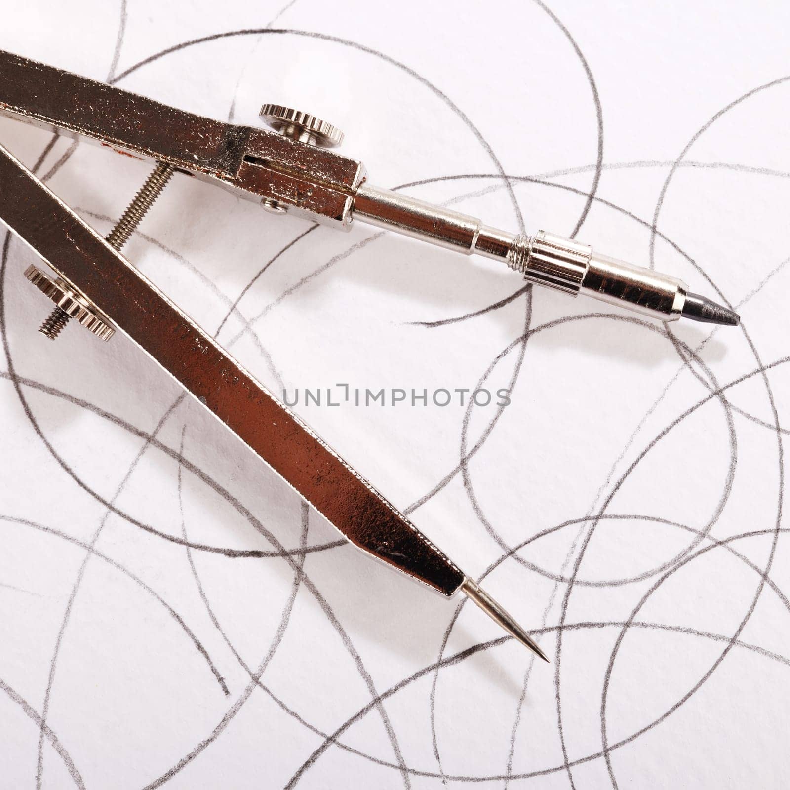 pair of compasses drawing on paper