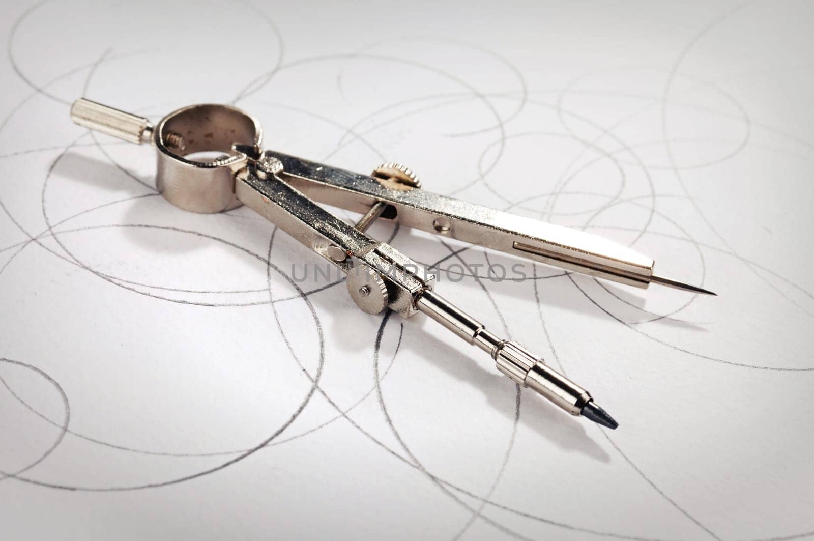 pair of compasses drawing on paper