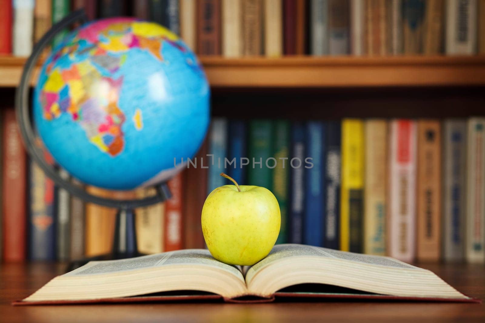 apple and book on background bookcase