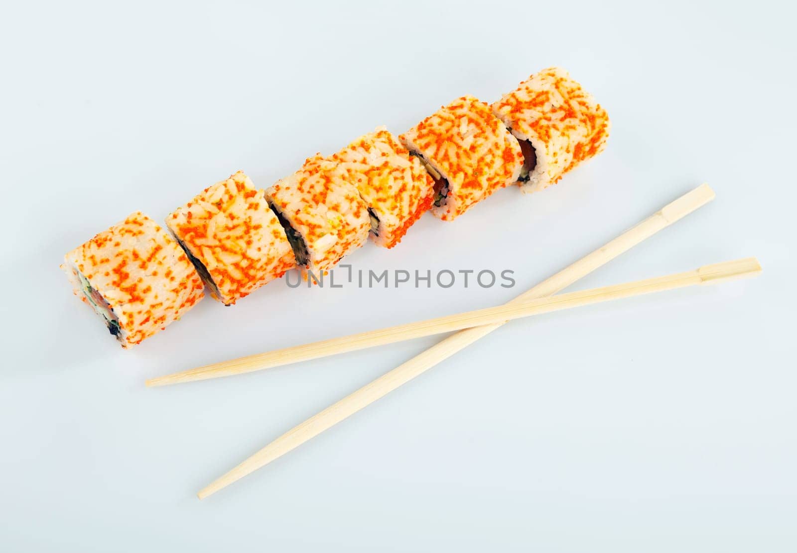 Traditional japanese sushi and chopsticks isolated on white background top view