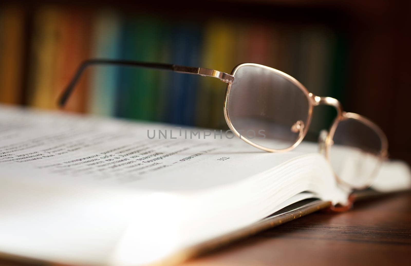 glasses and book on background bookcase