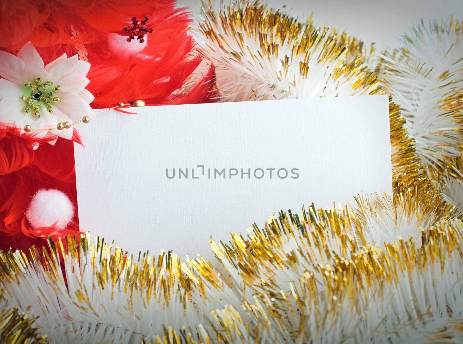 red christmas tree made of feathers with greeting cards