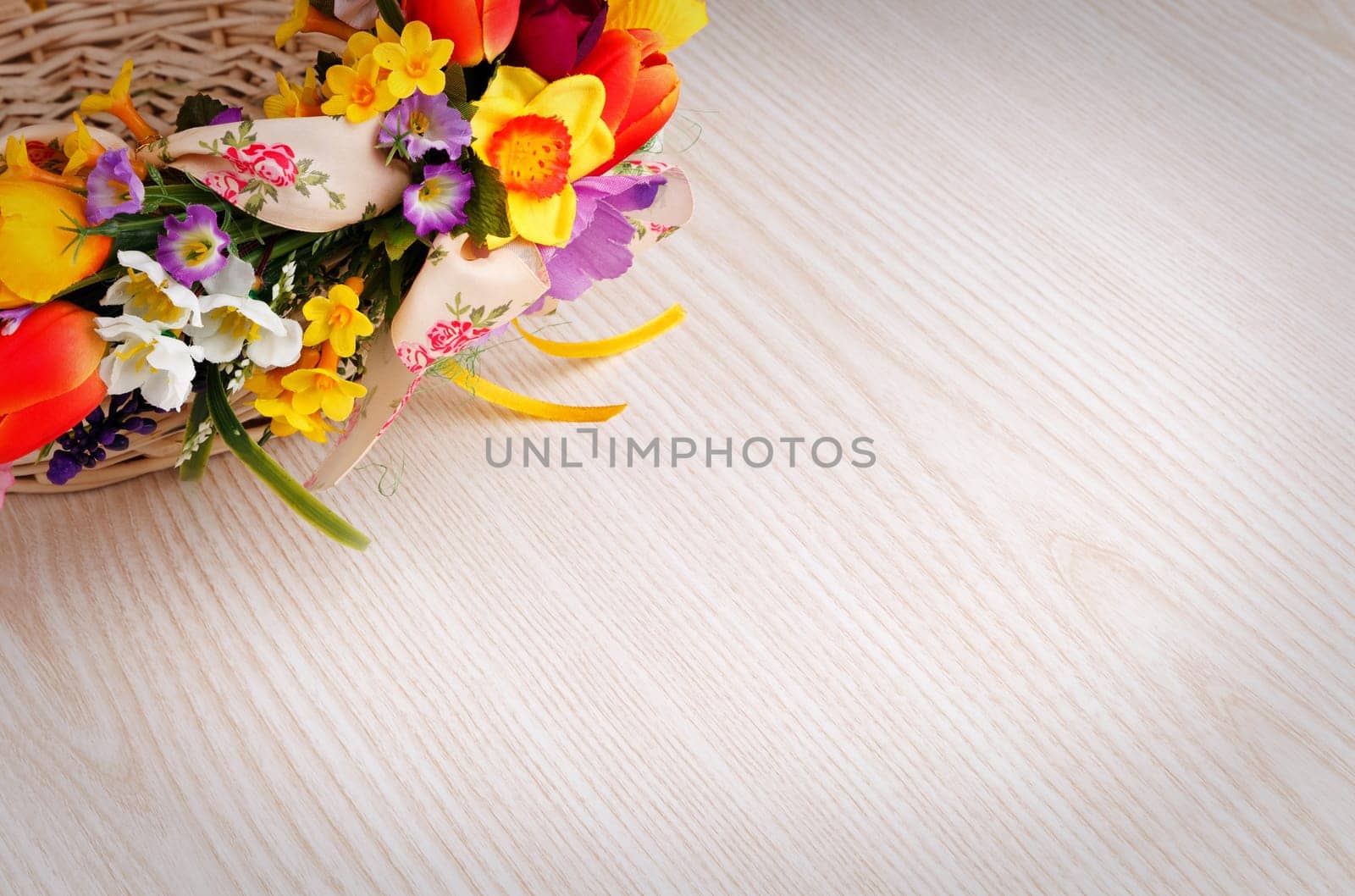 artifical flowers on a wooden background