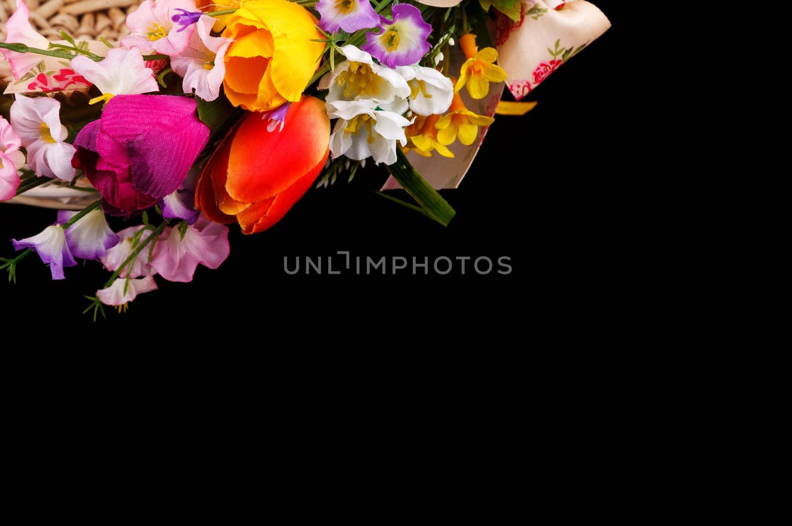 artifical flowers on a black background