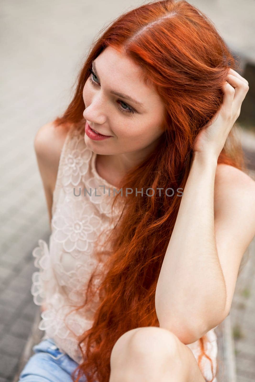 Attractive young woman with long root hair and straw hat outdoors in spring summer in blue sky