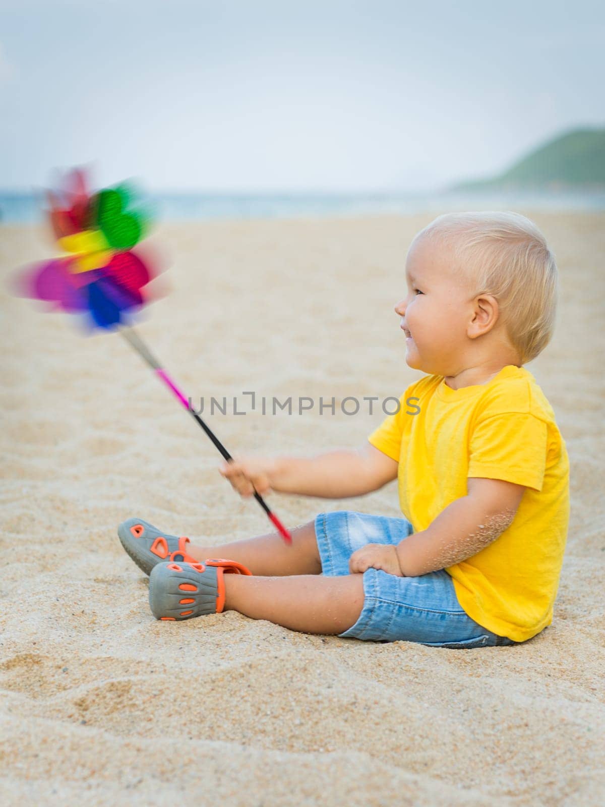 Baby playing with toy windmill
