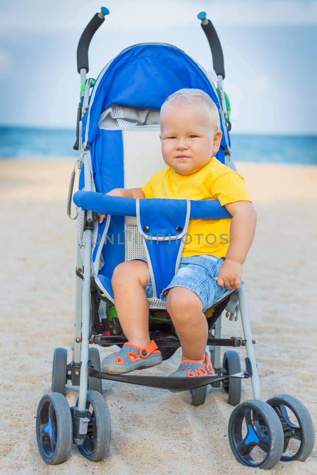 Adorable baby sitting in stroller