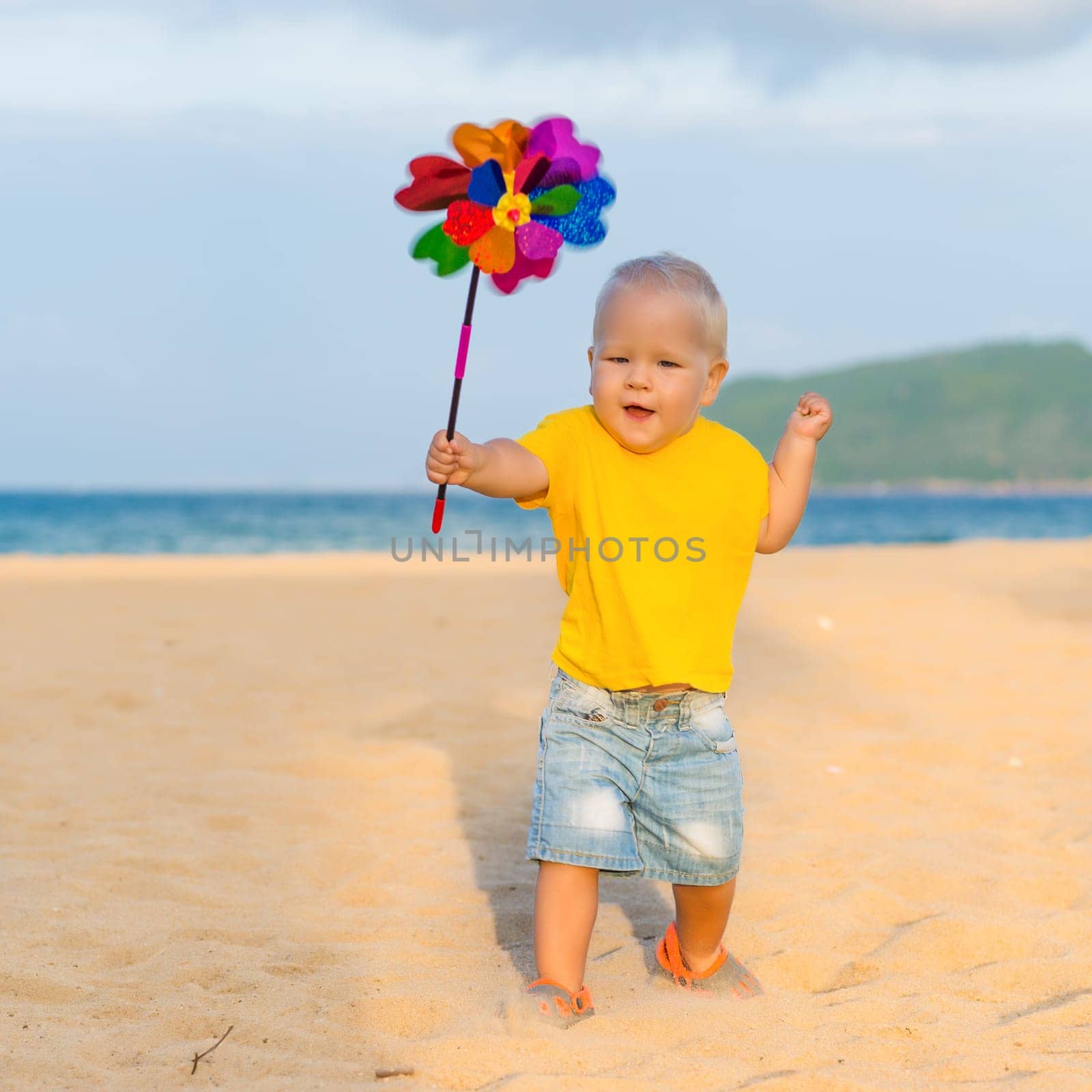 Baby playing with toy windmill