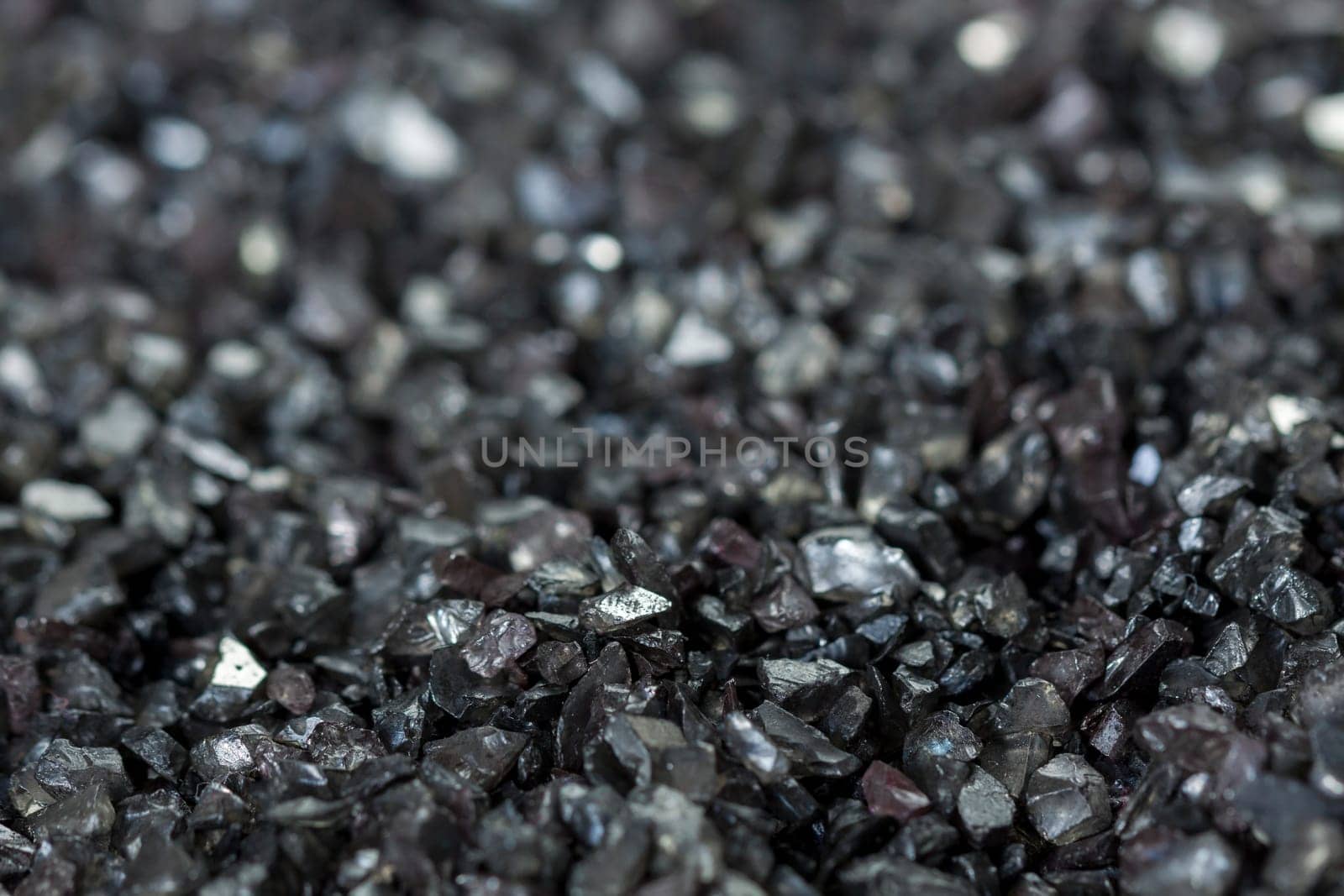 granular black asphalt in fine granules as close-up