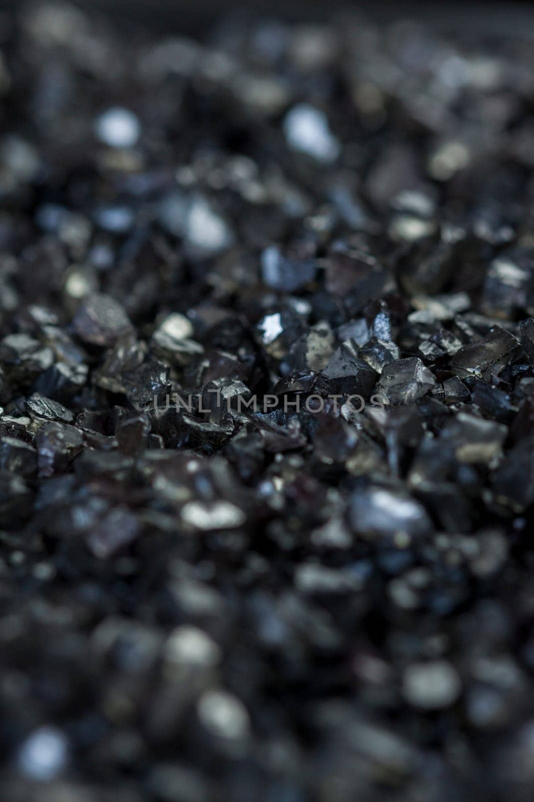 granular black asphalt in fine granules as close-up