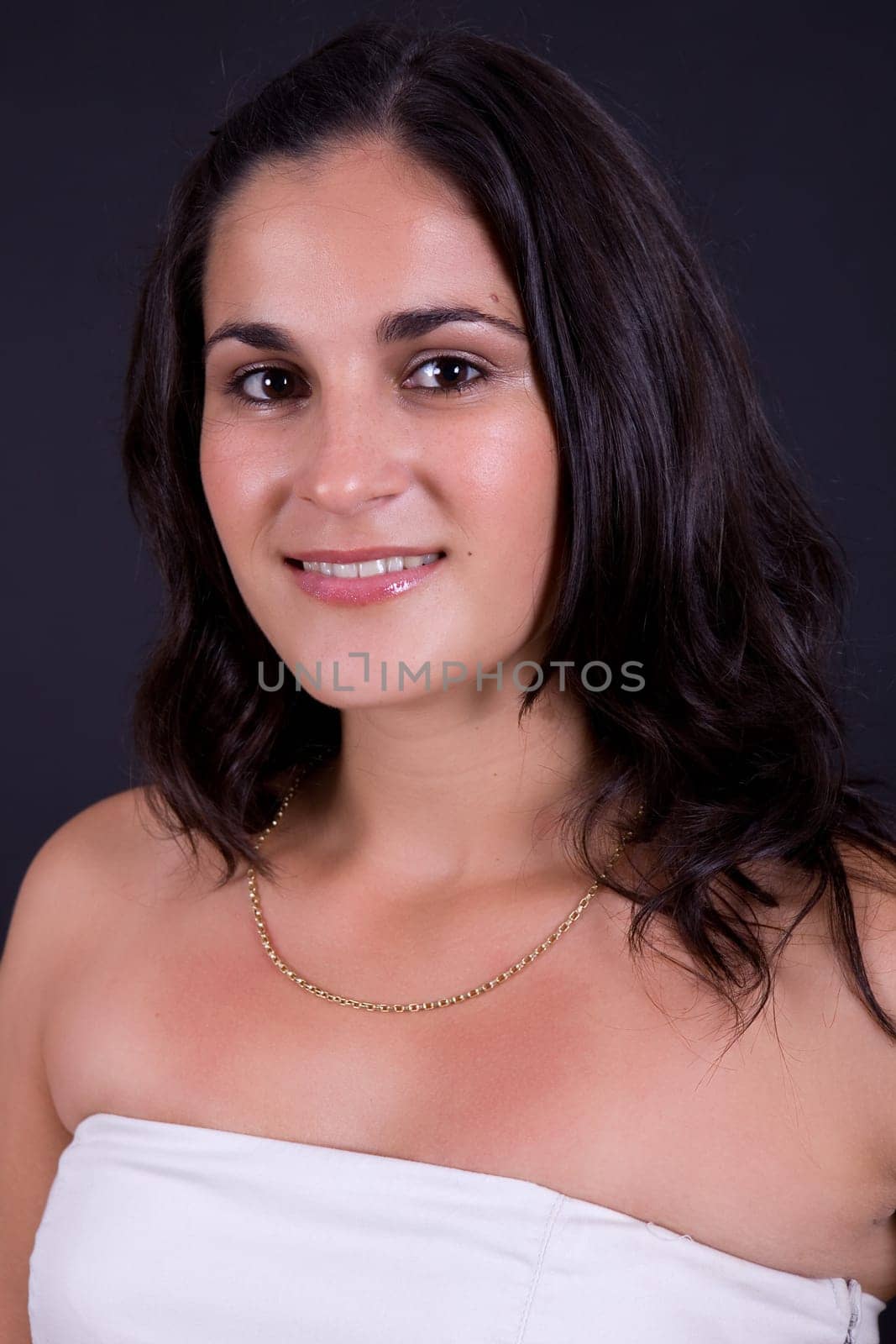 young beautiful brunette portrait against black background