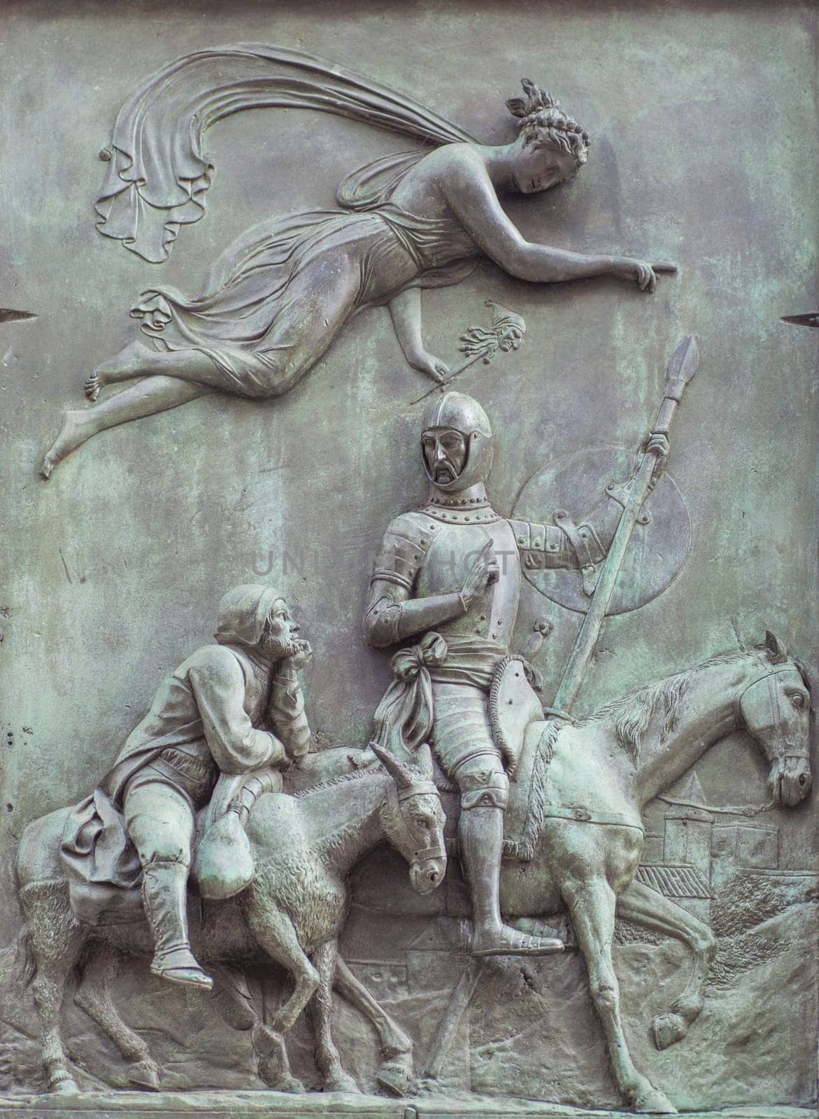 Spain, Madrid - March 6th, 2021:.Bronze reliefs with Don Quixote scene. By Jose Piquer Duart, 1835. Don Quixote and Sancho Panza driven by the goddess of madness. Miguel de Cervantes monument in front of Spanish Congress of Deputies, Madrid