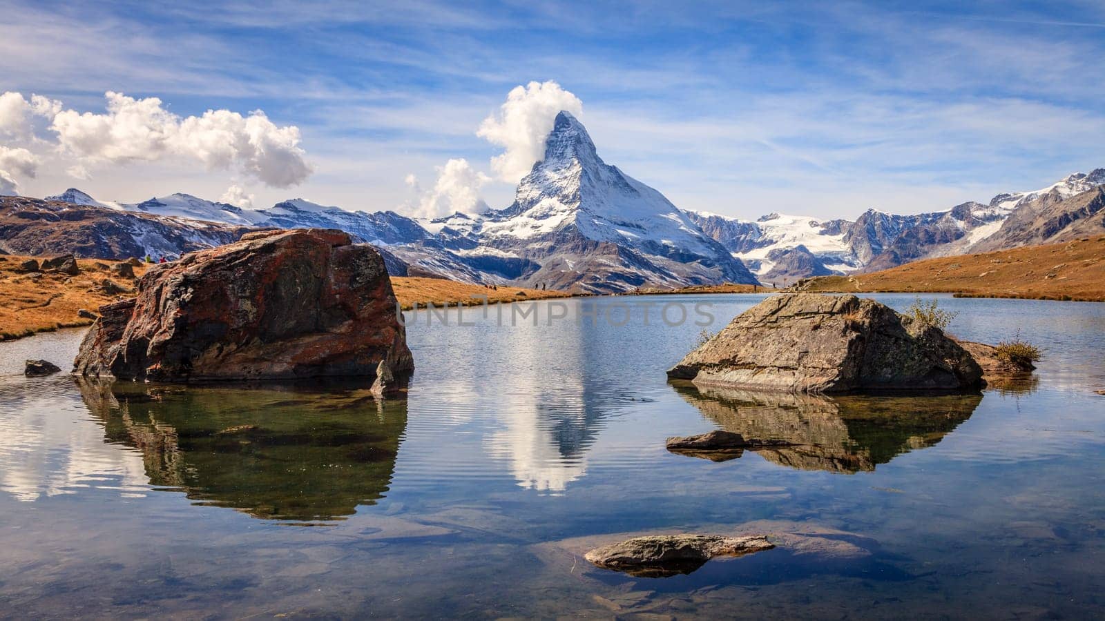 Famous alpine peak Matterhorn reflected in a pond in the Swiss Alps